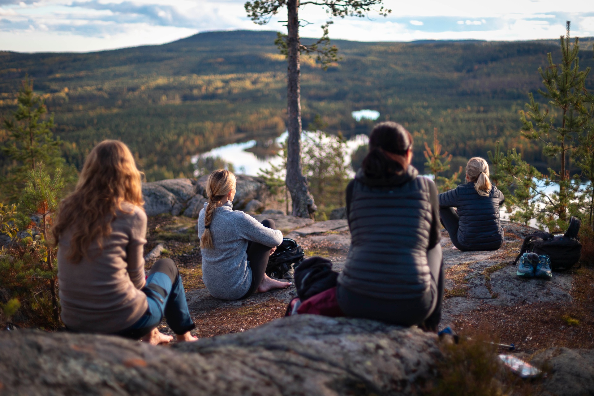 Women resting on a cliff overlooking the Arctic valley